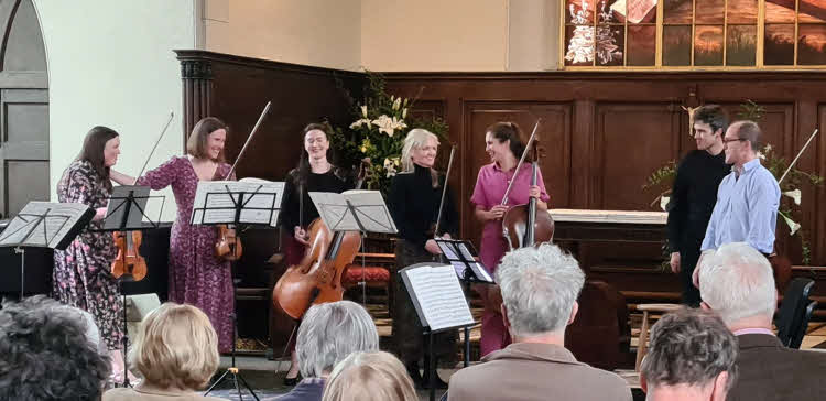 The players on their second return to the stage, enjoying well-deserved applause 2024 04 14 zoe beyer eso strings 2